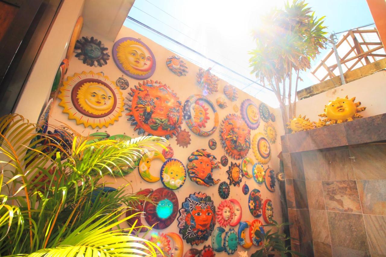 Papagayo Hotel Boutique Playa del Carmen Exterior photo A wall of the Sun God